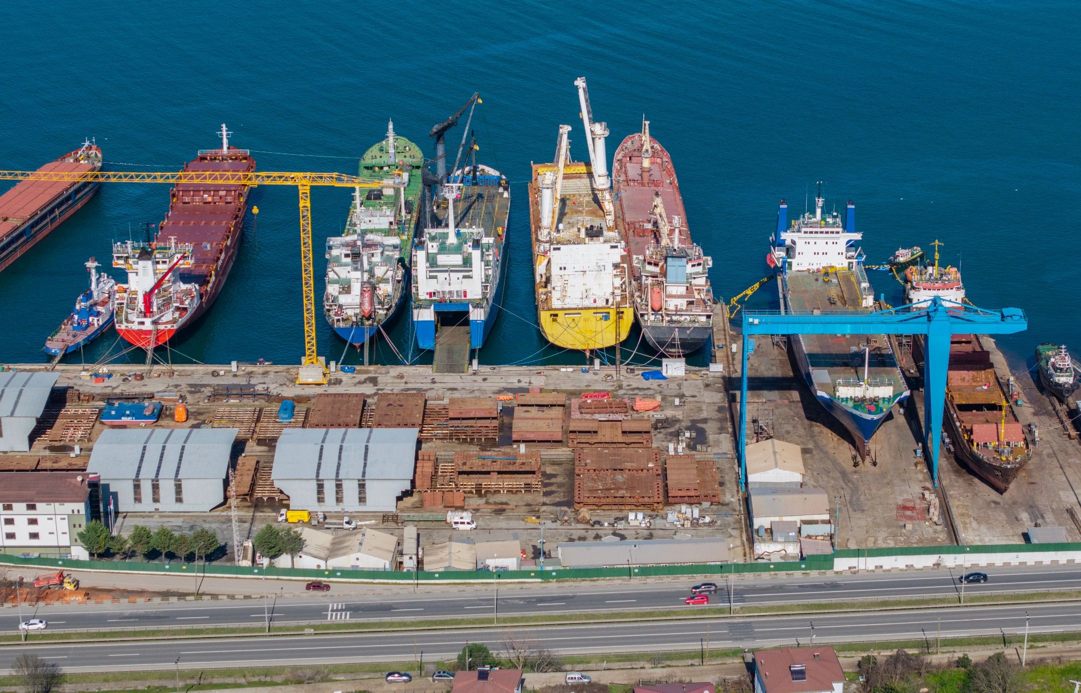Industrial shipyard with cargo ships and cranes