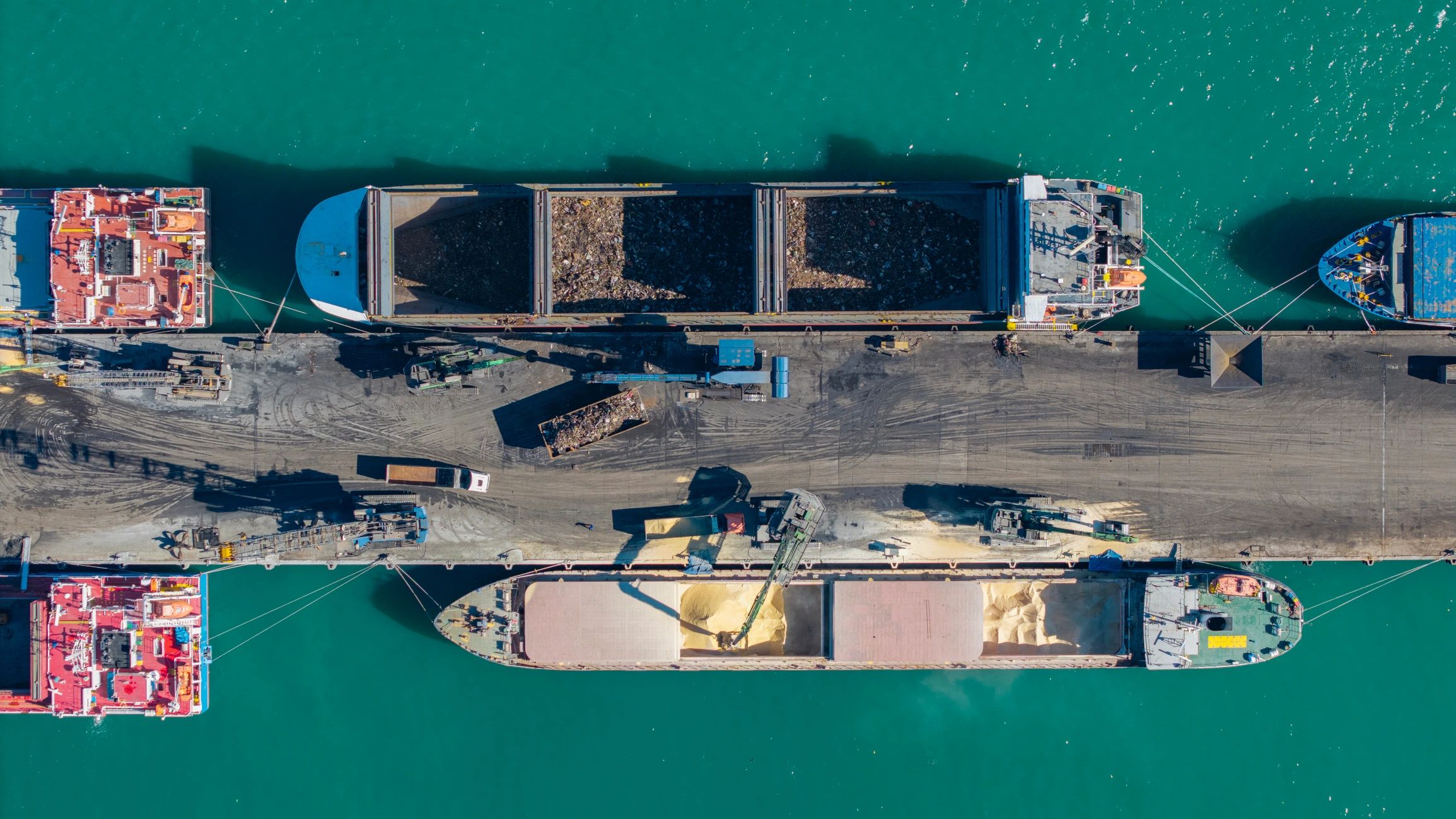 Aerial view of cargo ships loading at a commercial harbor